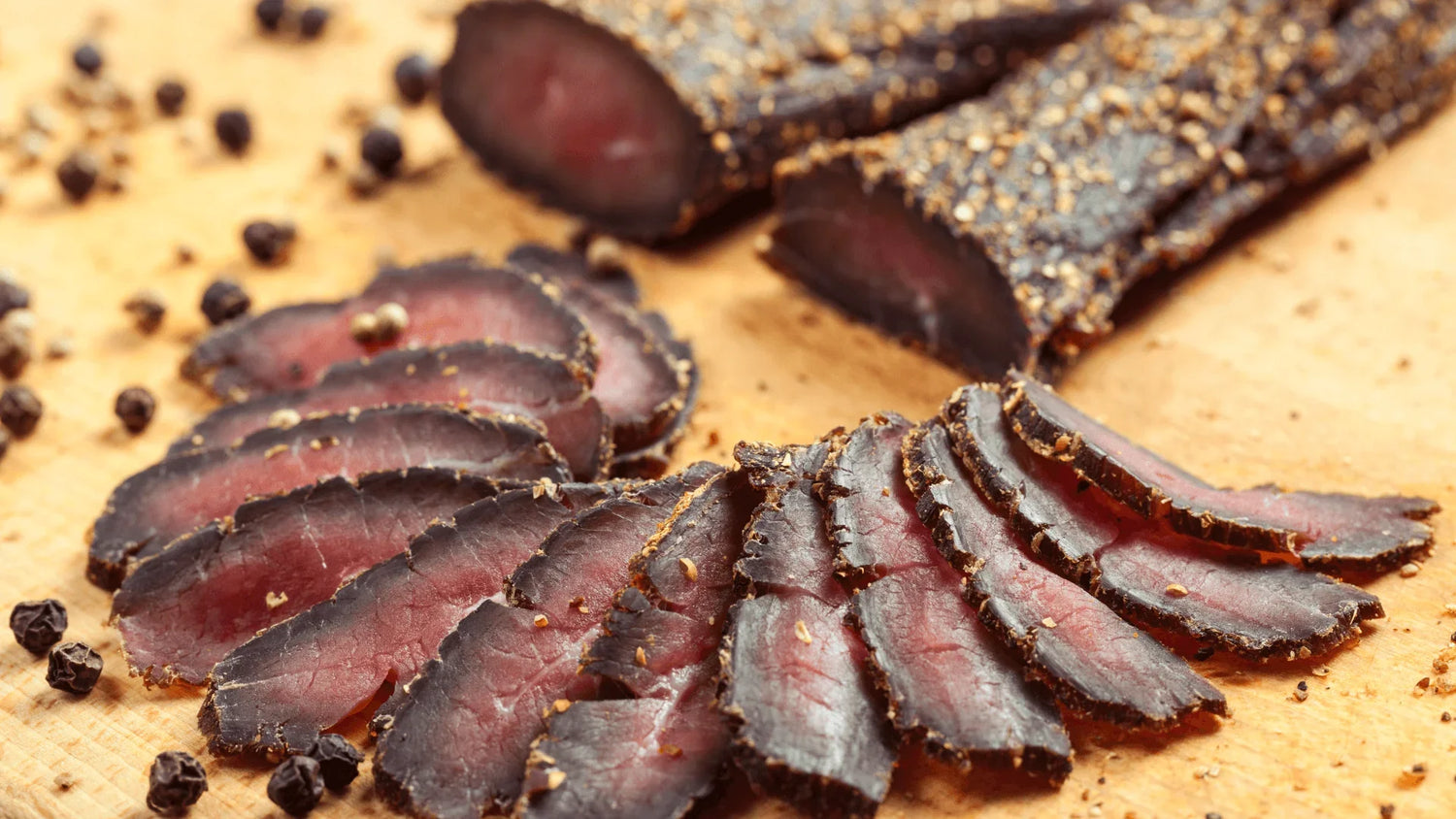 The image shows a sliced steak of biltong, a popular South African dried meat snack.